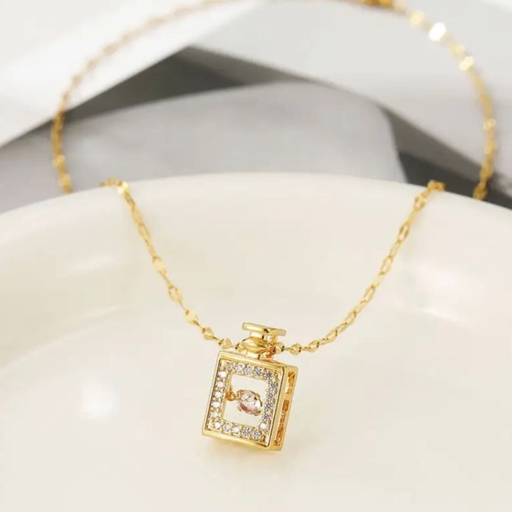 Gold Perfume Bottle With Dancing Diamond In Motion